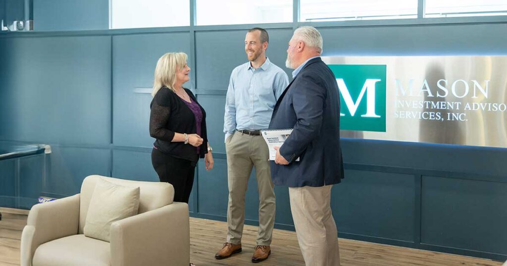 Group of Mason employees talking in conference room